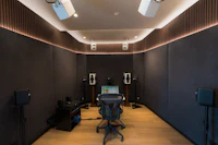 a recording studio with a desk and speakers